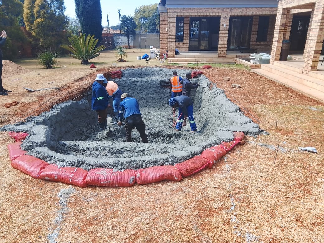 Crew building a custom marbelite pool from the ground up